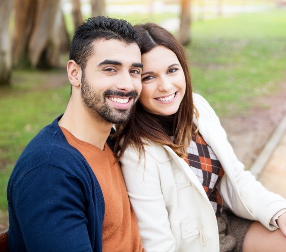 Man and woman with healthy smiles thanks to preventive dentistry