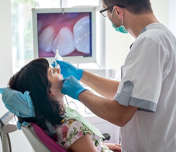 Dentist capturing smile images with intraoral camera