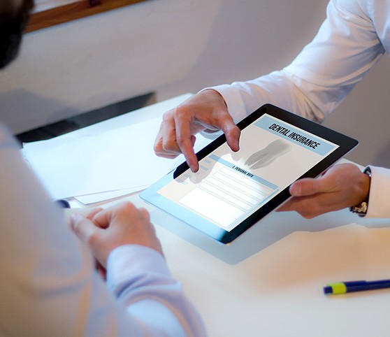 Patient looking at dental insurance form on tablet