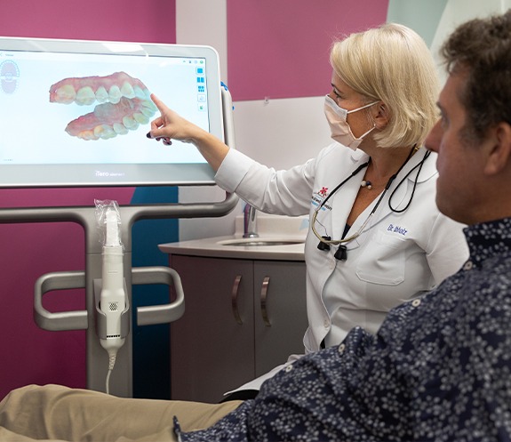 Doctor Obholz talking to dental patient