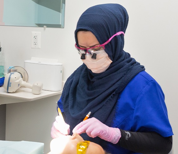 Dental team member treating dental patient