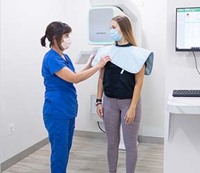 Dental team member capting patient's 3 D C T cone beam digital x-ray scanner