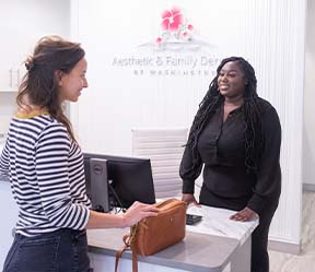 Friendly dental team member greeting dental patient