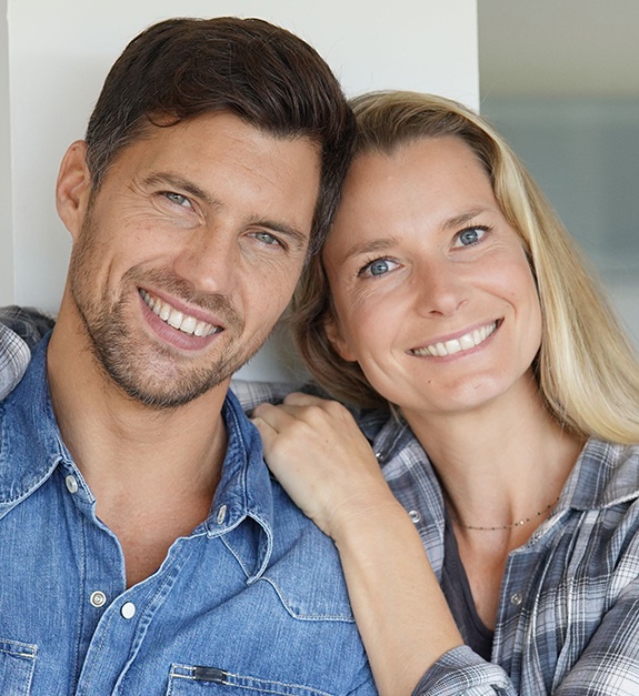 Man and woman with flawless smiles thanks to cosmetic dentistry