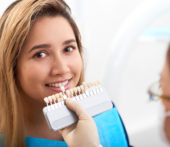 Woman's smile compared to porcelain veneer shade options