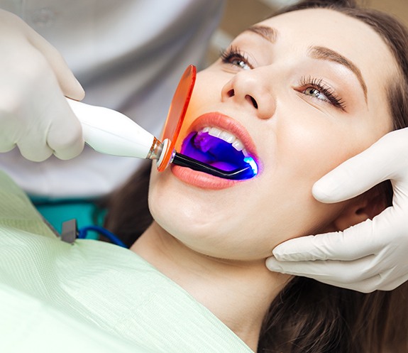 Dental patient receiving cosmetic dental bonding treatment