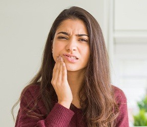 Woman with toothache before emergency dentistry