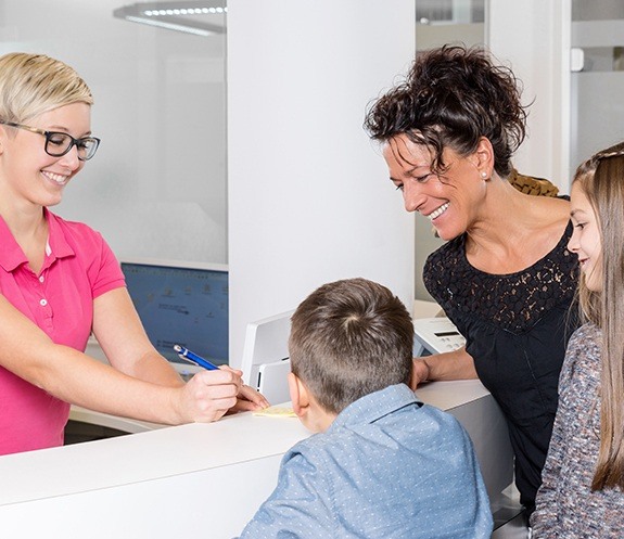 Family checking in at dental office for emergency dentistry