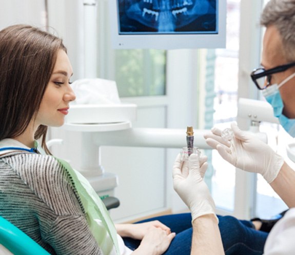 dentist showing dental implant in North Bethesda
