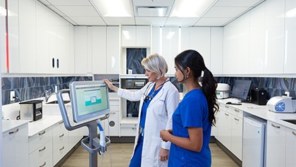 Doctor Obholz talking to dental patient