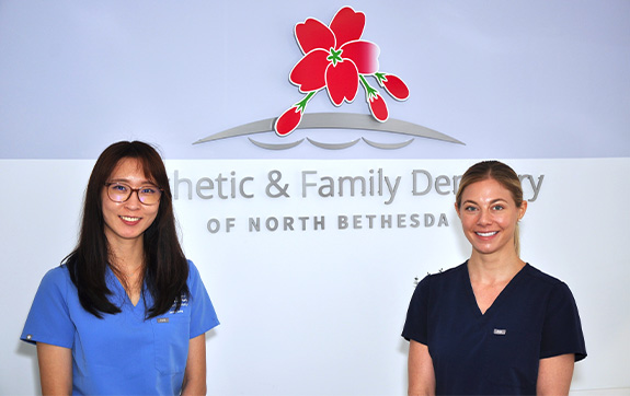 Dental team member and patient discussing in house dental savings plan