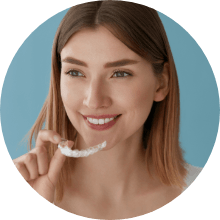 Woman placing an Invisalign tray