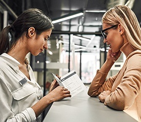 Dental team member and patient discussing in network dental insurance coverage