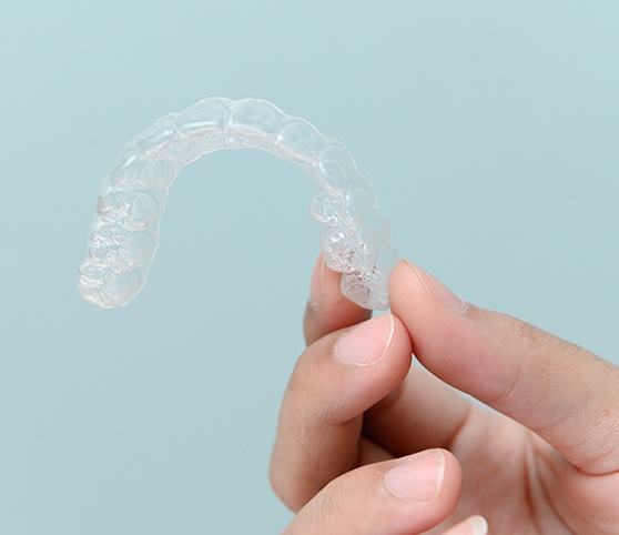 Patient holding clear aligner