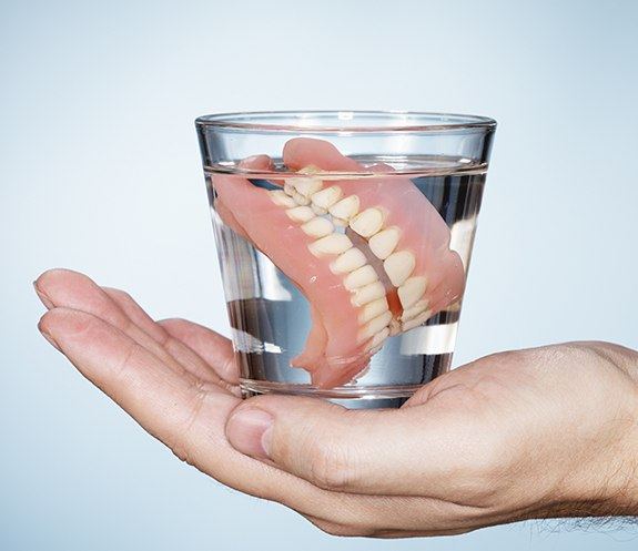 Full dentures in glass of water