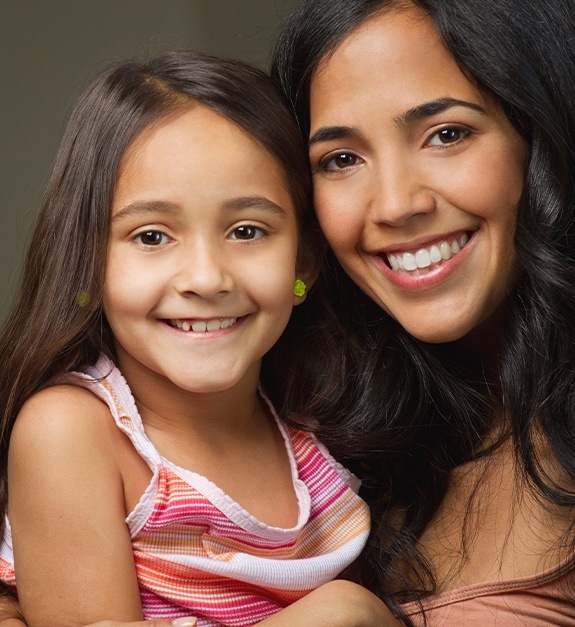 Mother and child smiling together after children's dentistry visit