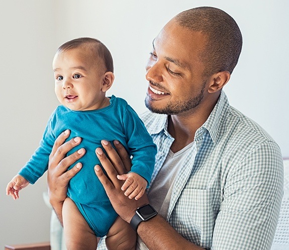 Father and baby smiling during child's first dental office visit