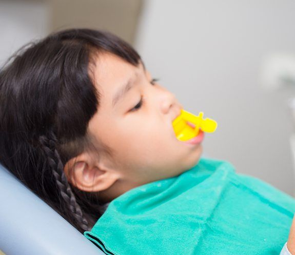 Child receiving fluoride treatment