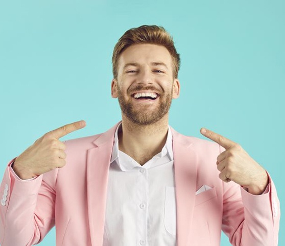 Man pointing at his healthy smile