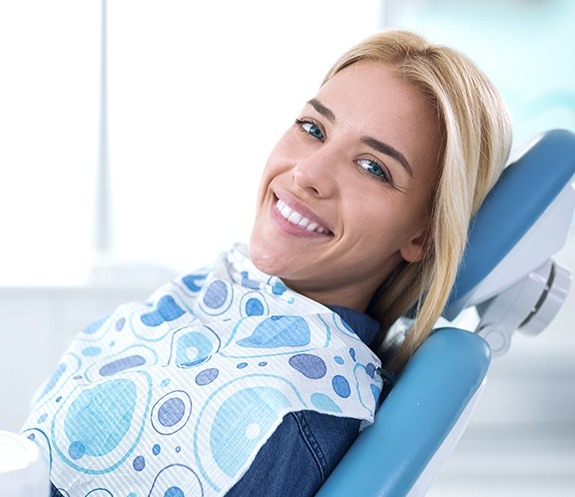 Woman with healthy smile after dental checkup and teeth cleaning visit