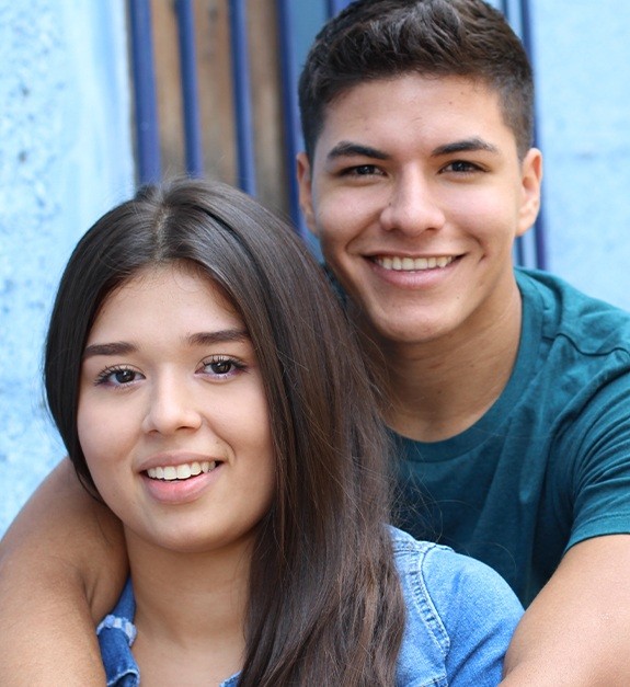 Two young people with healthy smiles after restorative dentistry