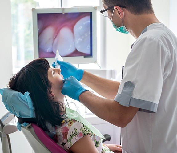 Dentist capturing smile images with intraoral camera