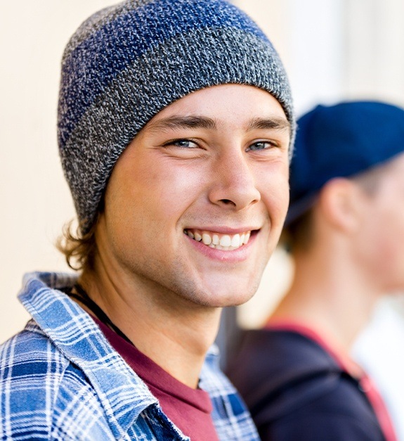 Young man with healthy smile after wisdom tooth extractions