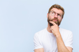 Man rubbing his chin in a questioning pose